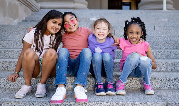Covers of Girl Scout activity books on pink background