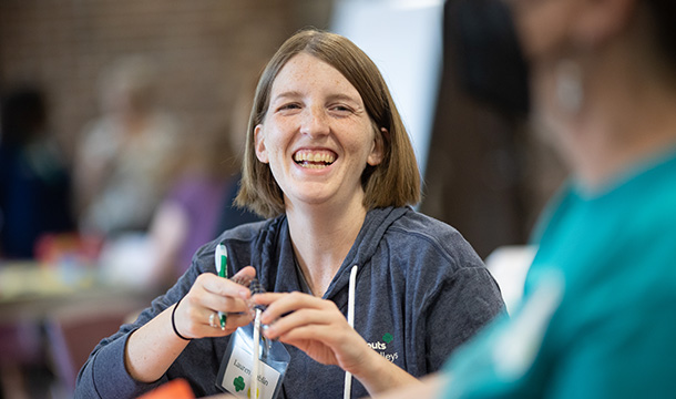 a smiling Girl Scout volunteer