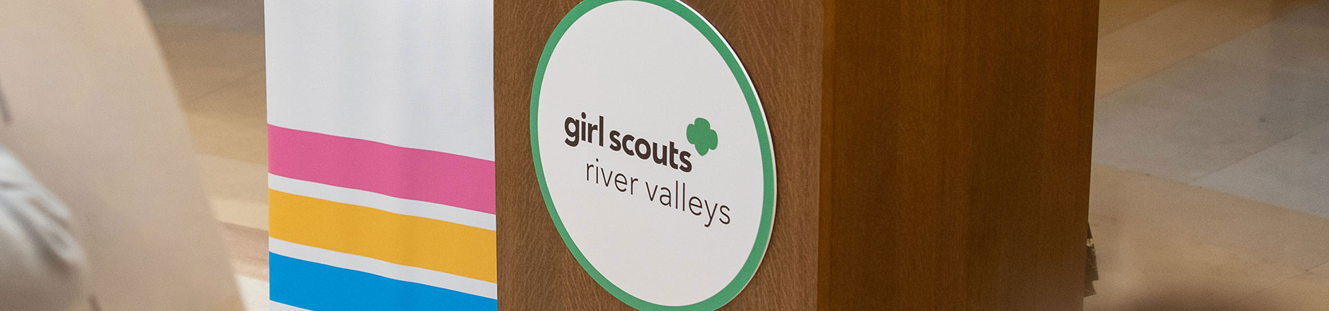  speaker podium with a Girls Scouts River Valleys sign 