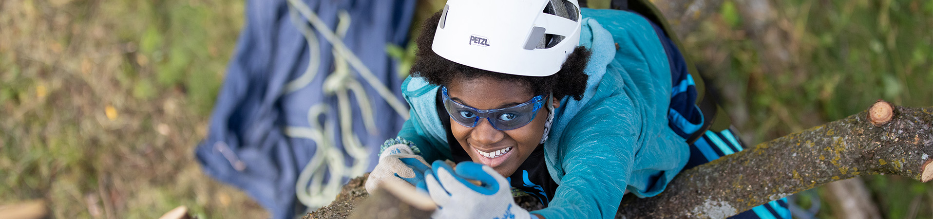  Girl Scout with climbing a tree with a helmet and ropes 