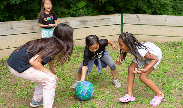 Girls playing the Gaga Ball game outside