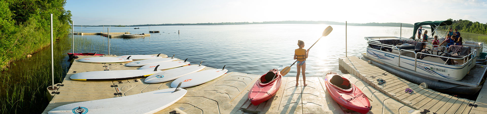  Girl standing next to kayak looking out at water 