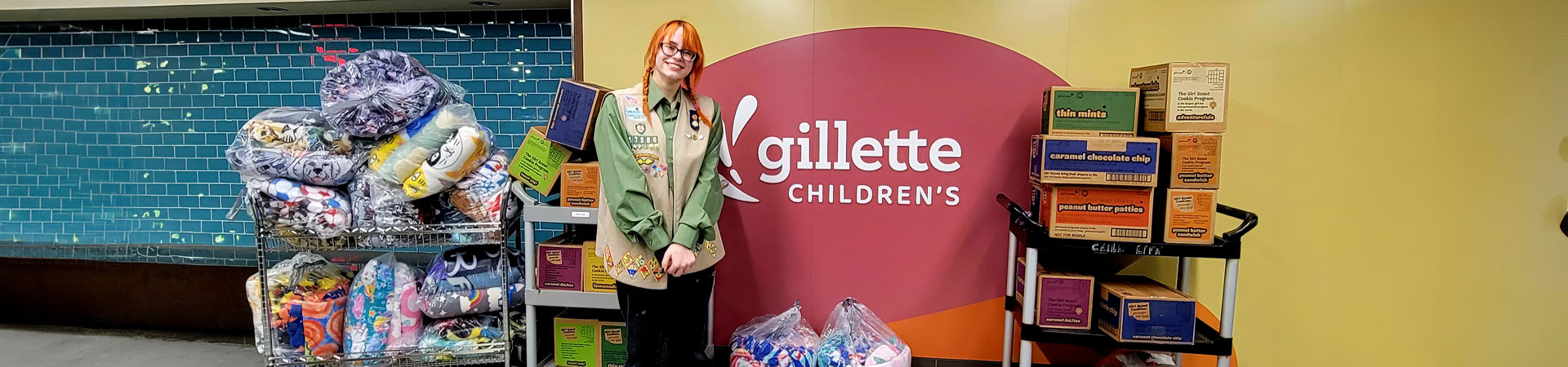  A Junior Girl Scout with carts of cookie donations at the Children's Hospital 