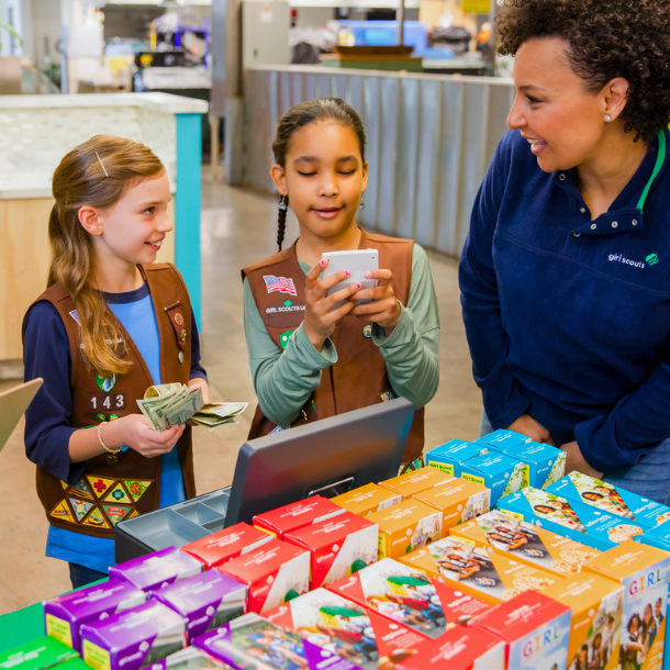 Girl Scout collecting money at cookie booth