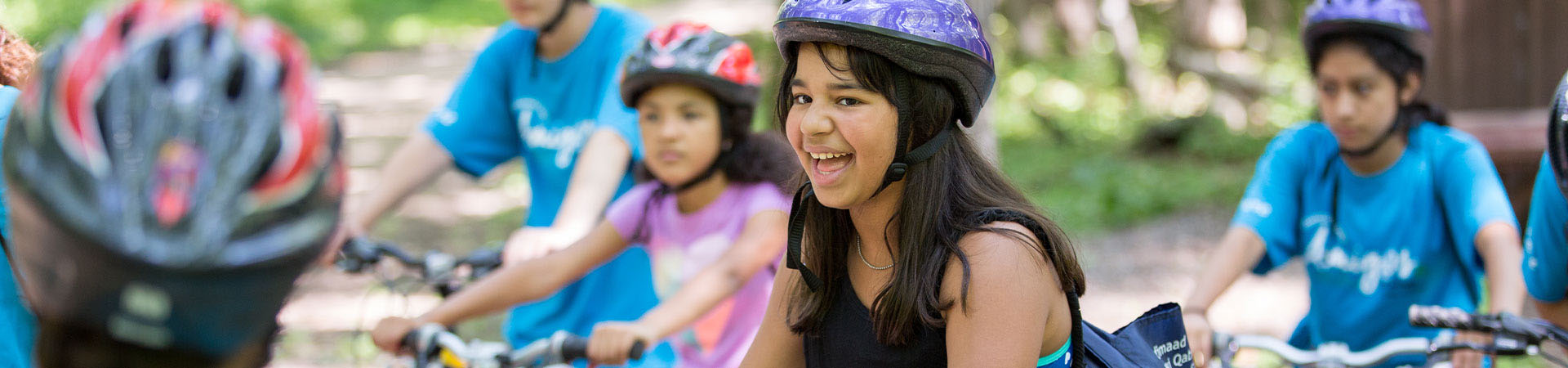  a group of Girl Scouts on bikes 