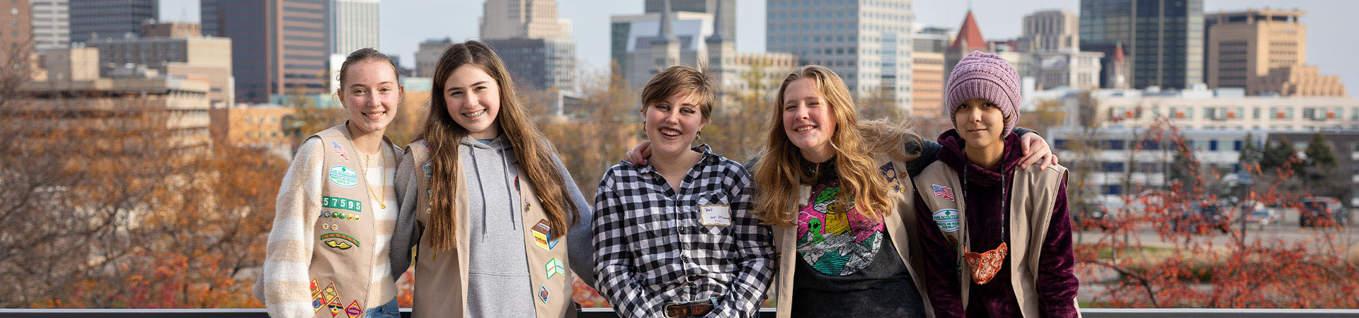  Group of Girl Scouts in front of a cityscape 