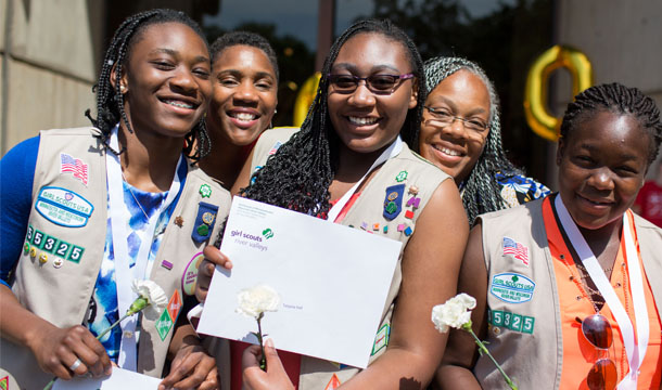 A group of Gold and Silver Awardees posing outside with their awards 