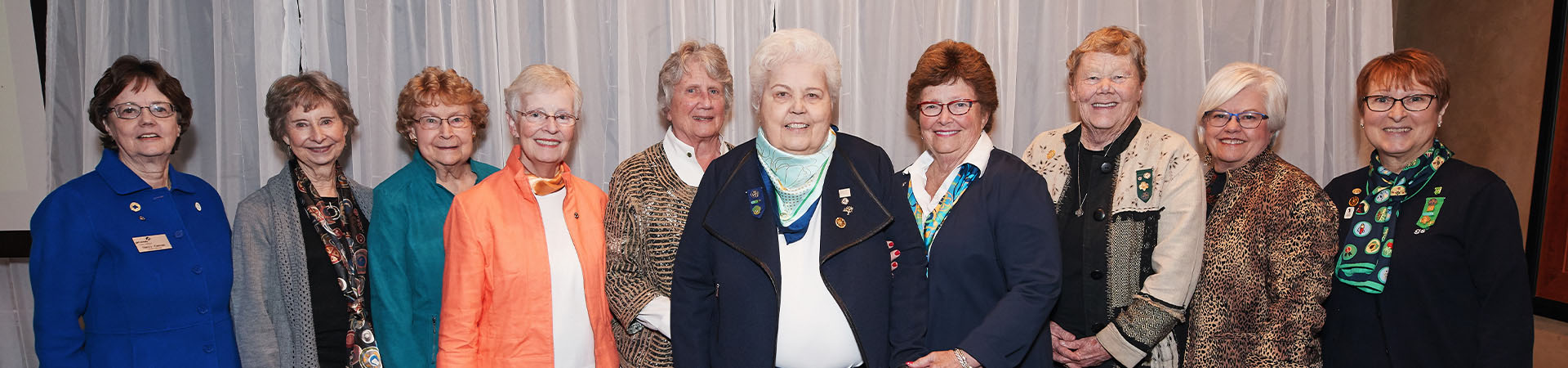  girl scout alum adult women retirement age smiling at camera 